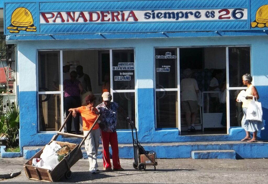 Mujeres con carros rústicos frente a panadería en Cuba. Foto: Francis Sánchez.