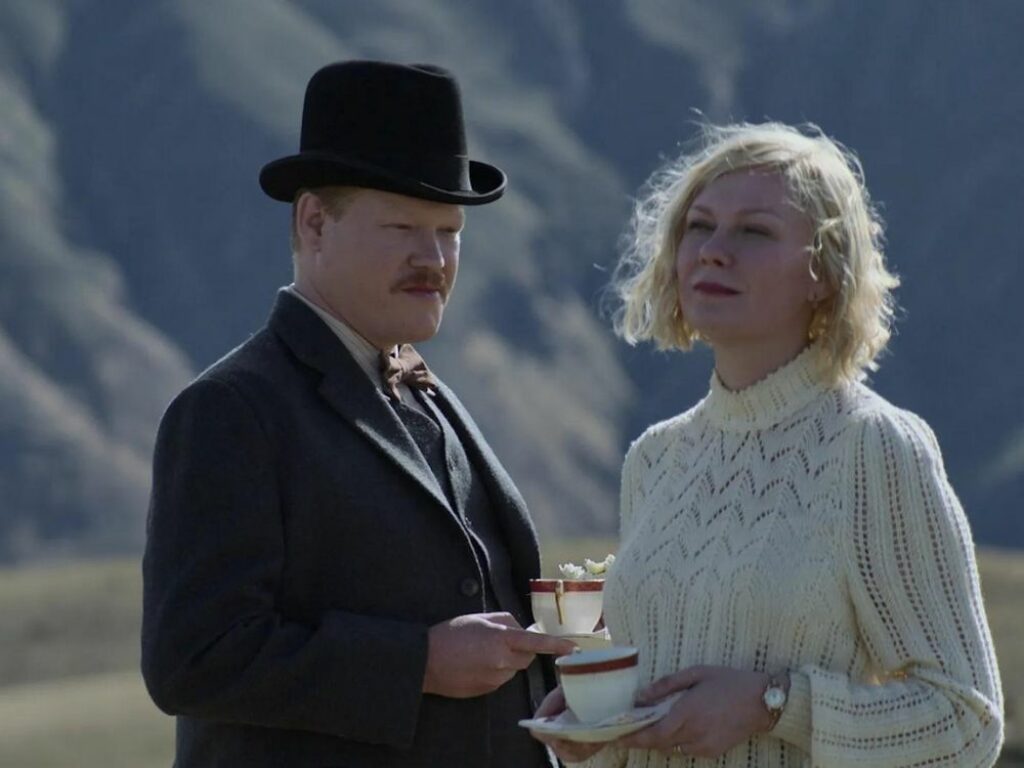 un hombre y una mujer conversan mientras toman té en el campo.