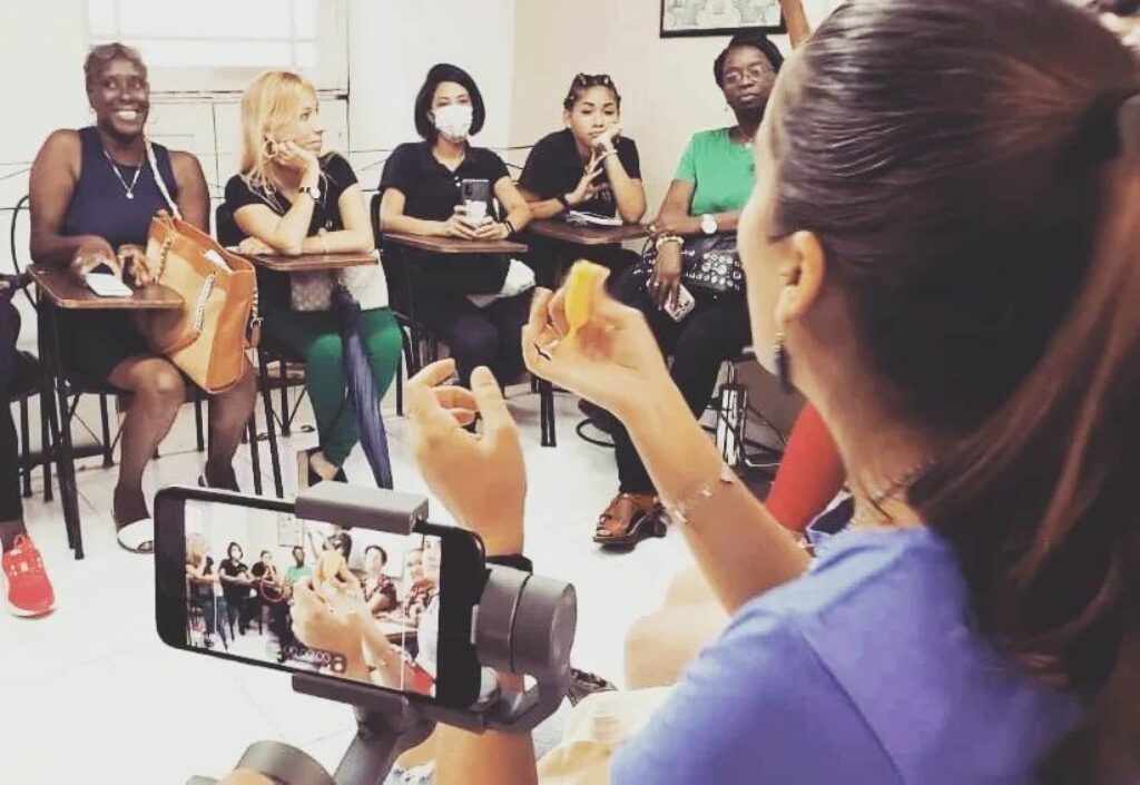 Mujer muestra la copa menstrual a un grupo de personas durante un taller del proyecto eoclógico La Mina.