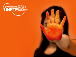 Cartel de “Campaña Únete” contra la violencia machista: Una mujer o niña pone su mano delante (pintada de naranja) en señal de "stop".