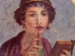 Joven poetisa Safo en un fresco pompeyano representada con libro y pluma en las manos.